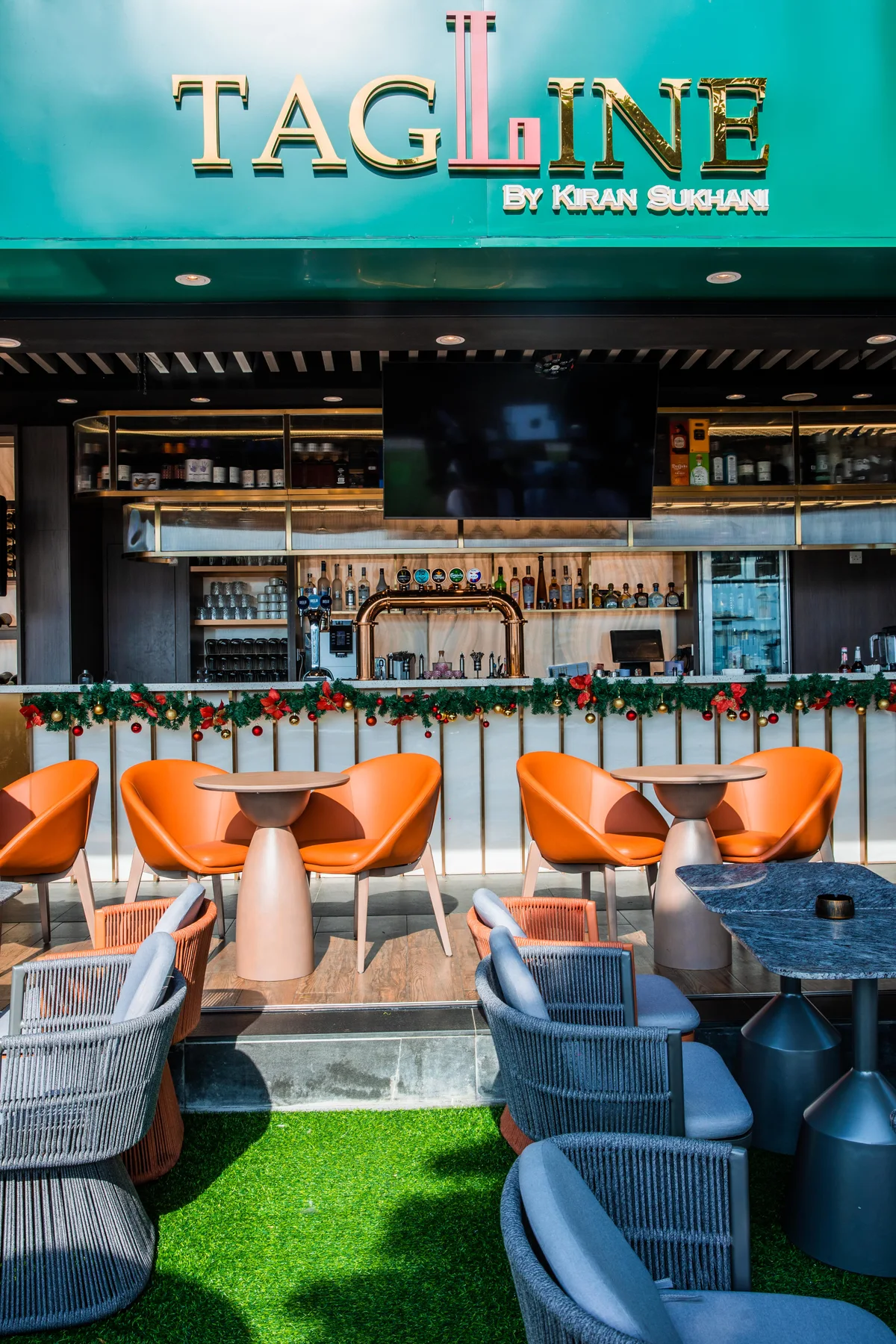 Tagline’s bar, with bottles behind the counter and seats on the patio